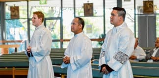 Sam French, left, Roger Delmonte and Aldrin Valdehueza make their profession of faith to Bishop Anthony Randazzo at Our Lady of the Rosary Cathedral, Waitara. Photo: Diocese of Broken Bay