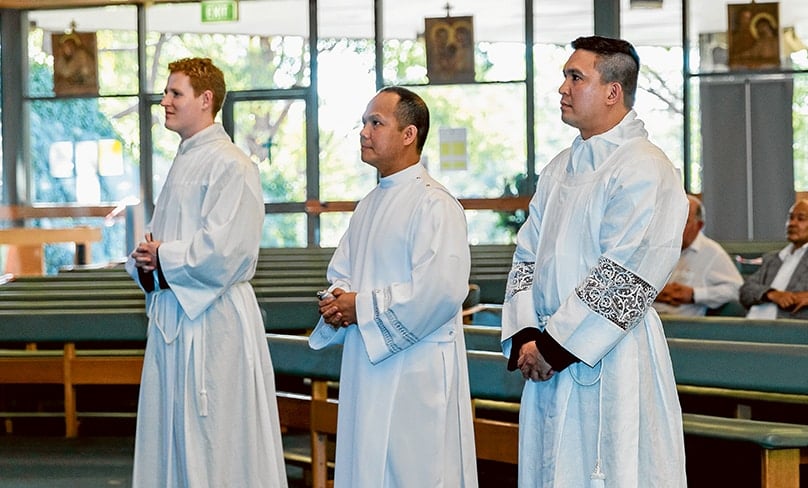 Sam French, left, Roger Delmonte and Aldrin Valdehueza make their profession of faith to Bishop Anthony Randazzo at Our Lady of the Rosary Cathedral, Waitara. Photo: Diocese of Broken Bay