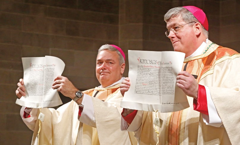 Solemn moment: Auxiliary Bishops Robert Fisher and Gerard Battersby of Detroit in the US hold copies of the apostolic mandates authorising their consecration to the episcopate in 2017. Photo: CNS, Larry Peplin, The Michigan Catholic
