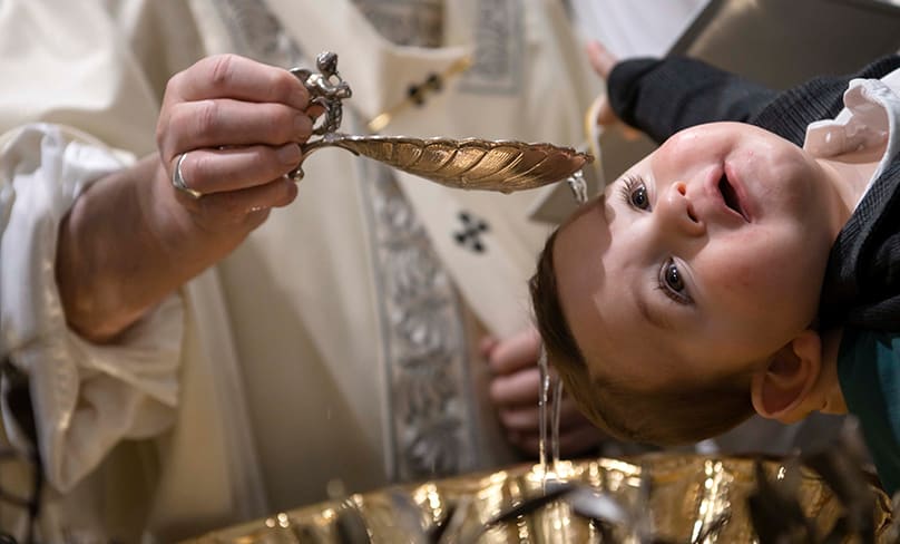 A baby is baptised on the feast of the Baptism of the Lord in the Sistine Chapel at the Vatican. Photo: CNS photo/Vatican Media