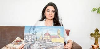 Syriac Catholic artist Ghusoon Durdur with her painting depicting the invasion of her parish by ISIS in Northern Iraq. Photo: Giovanni Portelli