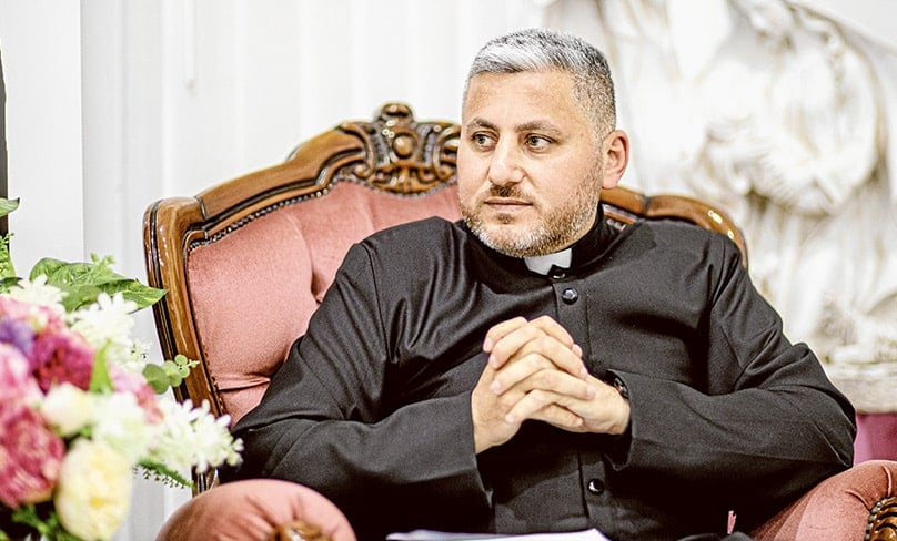 Syriac Catholic Fr Lenard Ina, pictured in his presbytery in Fairfield. Photo: Alphonsus Fok