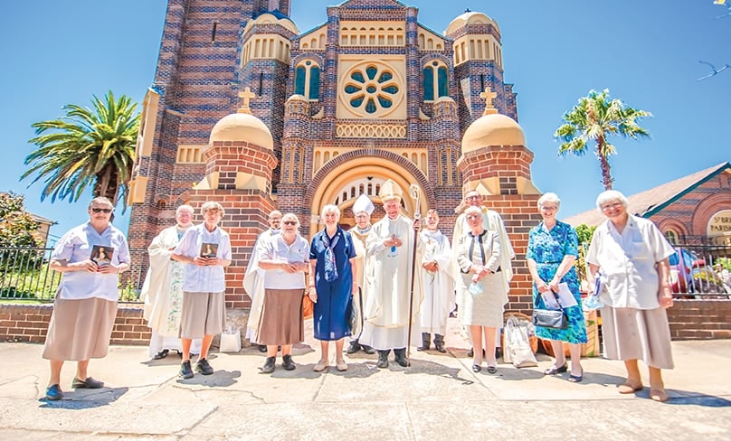 Bishop Terry Brady, fellow clergy and Sisters of Our Lady’s Nurses for the Poor gather outside St Brigid’s Church in Coogee last week to honour the young woman they hope will one day become Australia’s next official saint. Photo: Giovanni Portelli 