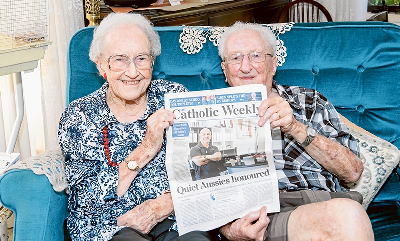 Denis and Claire Garty hold a copy of their favourite read, The Catholic Weekly. Photo: Giovanni Portelli