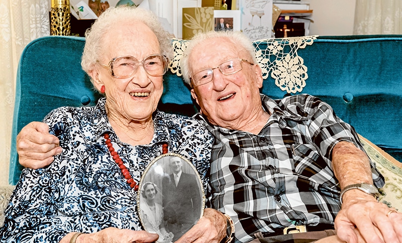 A lifetime of love, faith and reading The Catholic Weekly: Denis and Claire Garty relax at home in Wyoming as Claire holds a photo of the couple on their wedding day. Photo: Giovanni Portelli