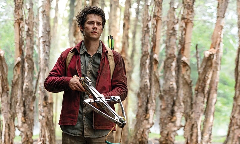 Joel Dawson, played by Dylan O’Brien, makes his way across a monster infested land with crossbow in hand to reunite with his girlfriend. Photo: Jasin Boland/Netflix