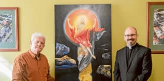 Artist Michael Galovic (at left) and Fr Paul Smithers who commissioned ‘The Crucifixion Subsumed’ for St Joseph’s Church, Rosebery. Photo: Giovanni Portelli