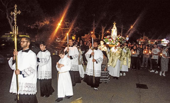 Following Holy Mass, the faithful were led out in procession around the grounds of the church and adjacent school amidst incense and candle light. Photo: Mat De Sousa
