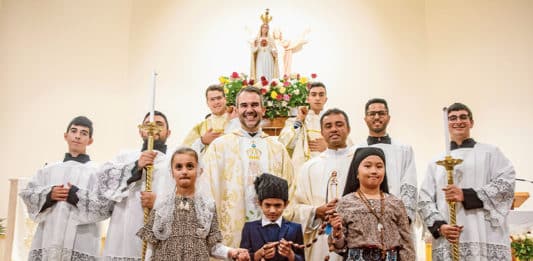 Making the evening particularly special, a selection of readings and prayers were said in Portuguese and three children were chosen from amongst the families of the parish to dress up as the three shepherd children of Fatima and take prominent position in the procession. Photo: Mat De Sousa
