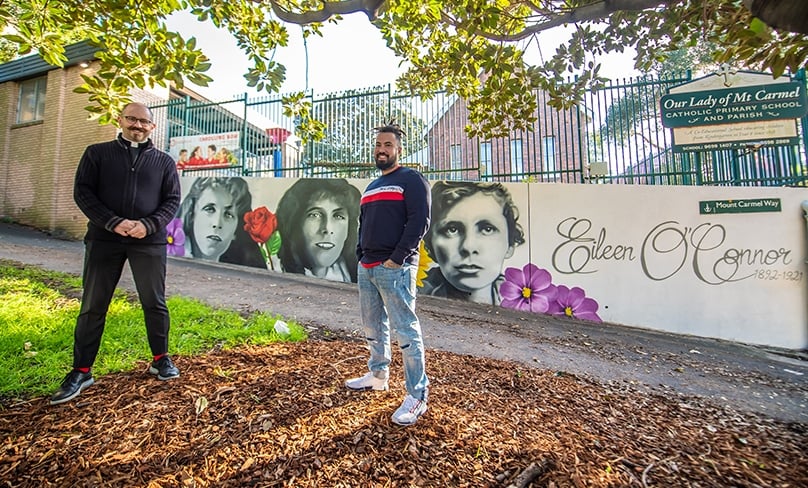 City South Parish Priest Fr Paul Smithers and artist Danny Mulyono stand in front of the new mural celebrating the life of Servant of God Eileen O’Connor. Photo: Giovanni Portelli