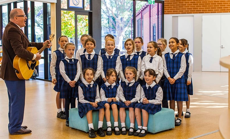The inaugural Principal of St Joseph's Rosebery, Bernard Ryan with students. Photo: Sydney Catholic Schools.