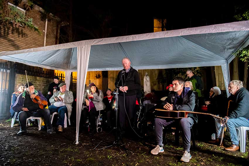 Bishop Terry Brady leads prayers for the homeless at a gathering in Elizabeth Bay in late June, 2021. Photo: Giovanni Portelli