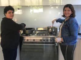 Volunteers Caroline and Jacob Badra, volunteers with ‘Food for Friends’, prepare a meal for fellow parishioners in need.