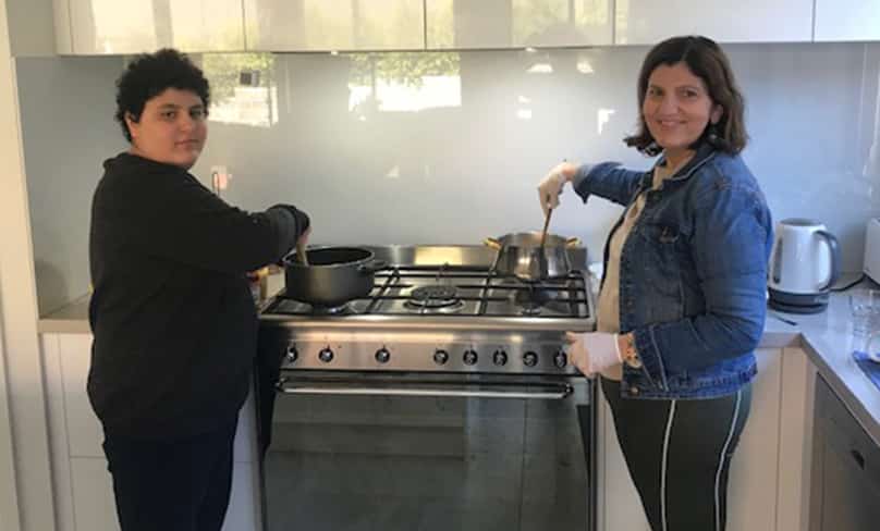 Volunteers Caroline and Jacob Badra, volunteers with ‘Food for Friends’, prepare a meal for fellow parishioners in need.
