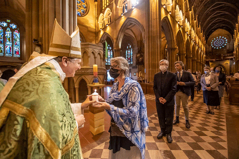 Archbishop Anthony Fisher OP presents a candle symbolising the light of the Plenary to Sydney delegate Francine Pirola. The event will now be held online due to Covid lockdowns. Photo: Giovanni Portelli