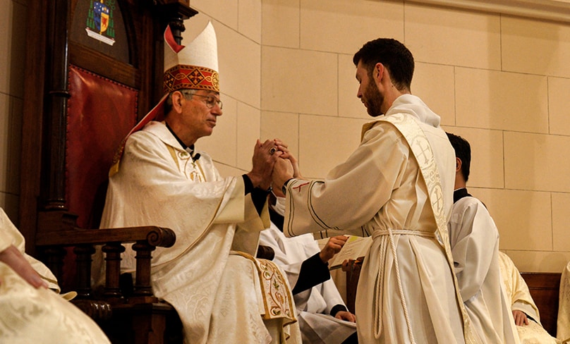 Bishop Mark Edwards OMI accepts a vow of obedience from the ordinand. Photo: Thomas Denahy