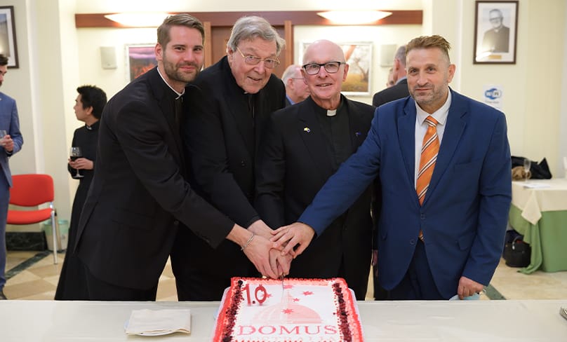 Cutting the cake: Deacon Andrew Kwiatkowski, Cardinal George Pell, Rector Fr Robert Hayes and Domus General Manager Fabrizio Petrocchi. Photo: Domus Australia