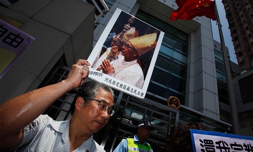 A protester carries a portrait of imprisoned Chinese Bishop James Su Zhemin of Baoding. Photo: CNS photo/Bobby Yip, Reuter