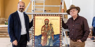 A delighted Fr Paul Smithers receives the completed icon of Our Lady Help of Christians from iconographer Michael Galovic. Photo: Alphonsus Fok