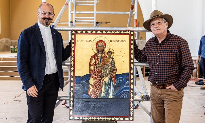 A delighted Fr Paul Smithers receives the completed icon of Our Lady Help of Christians from iconographer Michael Galovic. Photo: Alphonsus Fok