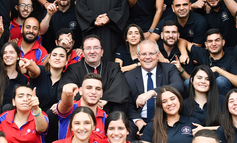 Prime Minister Scott Morrison and Bishop Antoine-Charbel Tarabay with young parishoners after Good Friday Easter services at St Charbel’s Catholic Maronite Church at Punchbowl in 2019. Photo: AAP, Mick Tsikas