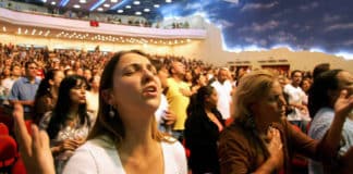 Christians pray inside Renascer em Cristo church in Sao Paulo, Brazil, in 2007. On that occasion, the church was filled with about 4,000 worshippers. Conversions to non-Catholic forms of Christianity are increasingly common throughout Brazil - and surging throughout other South and Latin American nations. Photo: CNS, Caetano Barreira, Reuters