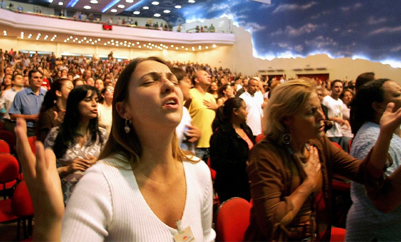 Christians pray inside Renascer em Cristo church in Sao Paulo, Brazil, in 2007. On that occasion, the church was filled with about 4,000 worshippers. Conversions to non-Catholic forms of Christianity are increasingly common throughout Brazil - and surging throughout other South and Latin American nations. Photo: CNS, Caetano Barreira, Reuters
