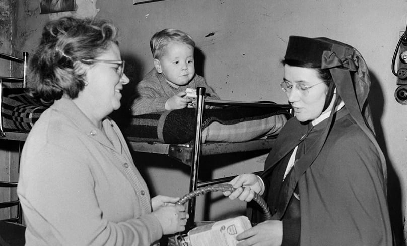 Sister Patricia Davis oln delivers a hamper of supplies to a family. Over six decades serving the people of Newcastle, the Sisters brought nursing care and other pastoral support to people’s homes. Photo: OLN