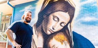 Brushing up on his skills … talented painter Danny Mulyono and his ‘spray-ting” of Mother Mary and baby Jesus. Photo: Giovanni Portelli
