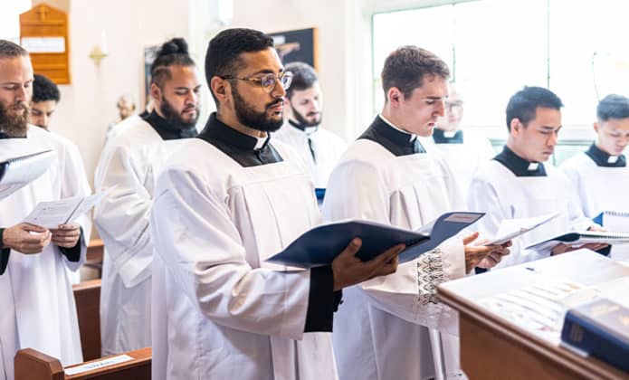 Seminarians sing in a Schola at the Mass. Photo: Alphonsus Fok