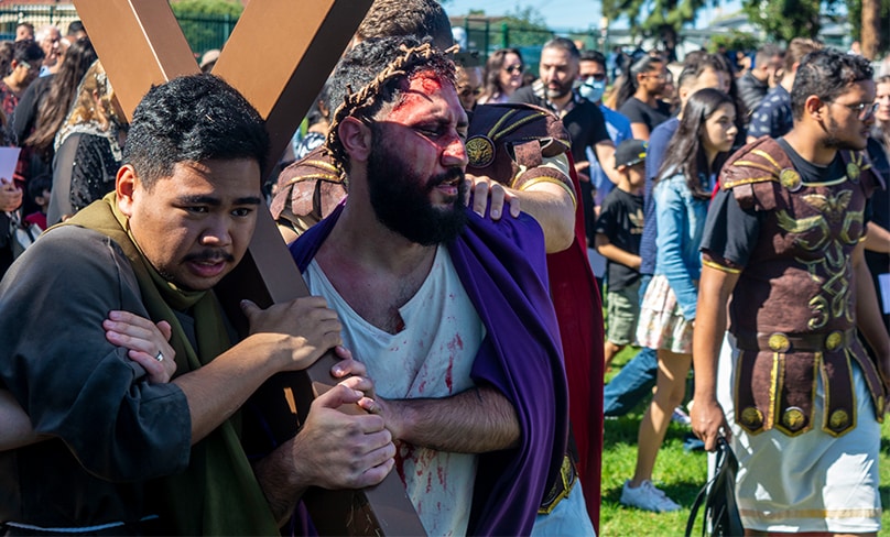 Somascan Young Adults Joel Capinig (left) and Robert Ianni lead the crowds as Simon of Cyrene and Jesus of Nazareth in a reenactment of the Stations of the Cross at St Joseph’s parish in Moorebank. Photo: Mat De Sousa
