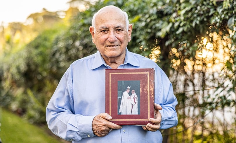 Paul Naggar with a photo of his Ordination to the Permanent Diaconate by Cardinal Clancy. Photo: Alphonsus Fok