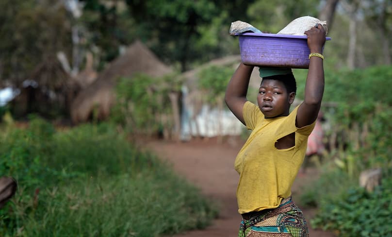 A woman who fled the Lord’s Resistance Army in Uganda, walks through the Makpandu refugee camp in southern Sudan in 2010. Photo: CNS/Paul Jeffrey