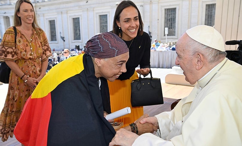 Theresa Ardler, a lecturer in Aboriginal Spirituality at ACU, meets Pope Francis last week. She presented him with a personal copy of the Uluru Statement from the Heart. Chiara Porro, Australia’s Ambassador to the Vatican, is centre of photo, and Jacqui Remond from ACU in the background. Photo: Vatican Media
