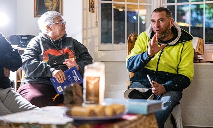Scenes from daily life: Sue Buckingham, (left to right, below) listens to Joe, a David’s Place regular, during a Friday night prayer gathering reflecting on the Gospel for Trinity Sunday. Photo: Alphonsus Fok