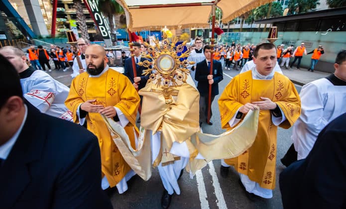 For Catholics it’s a unique experience: Archbishop Anthony Fisher OP carries the Blessed Sacrament through the streets of Sydney. Photo: Giovanni Portelli