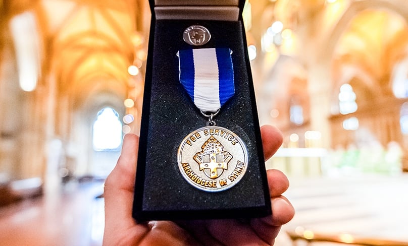 The 2022 Dempsey Medal is held up at St Mary’s Cathedral. Photo: Giovanni Portelli