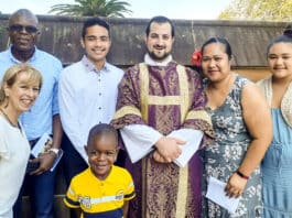 Tamburai Enoch Mutawemba, at left, with his son Joshua, Fr Roberto Keryakos and parishioners from All Saints Liverpool. Photo: supplied