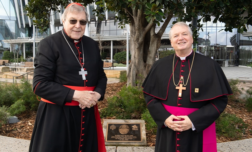 Archbishop Anthony Fisher OP and Cardinal George Pell in front of the new plaque at Barangaroo marking Pope Benedict XVI’s arrival for World Youth Day in 2008. Photo: Giovanni Portelli