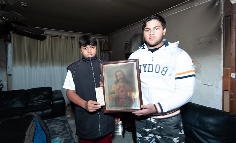 Two of the Wilson children with an image of the Sacred Heart of Jesus. Photo: Giovanni Portelli