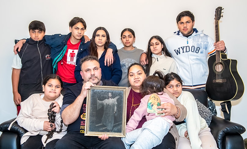 Warren and Amelia Wilson with their nine children aged 4-21 show the few possessions they were able to save. Photo: Giovanni Portelli