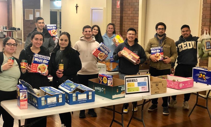 St Joseph’s Somascan  youth pack meals for needy parishioners. Photo: Supplied