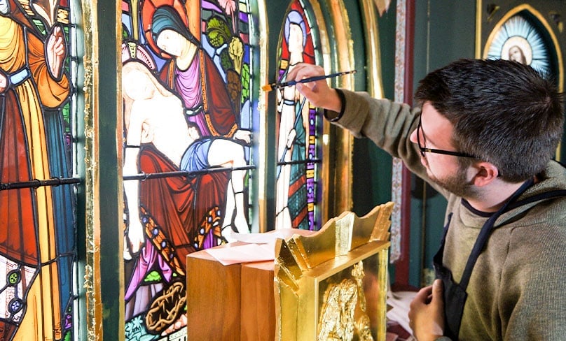 Damian Walker works on restoring stained glass to give it a new lease of life for generations to come. Photo: Supplied