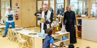 Infants enjoy the novelty as Bishop Daniel Meagher, accompanied by Fr Paul Smithers, blesses the new facilities with holy water. Photo: Alphonsus Fok
