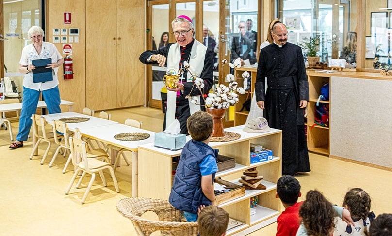 Infants enjoy the novelty as Bishop Daniel Meagher, accompanied by Fr Paul Smithers, blesses the new facilities with holy water. Photo: Alphonsus Fok