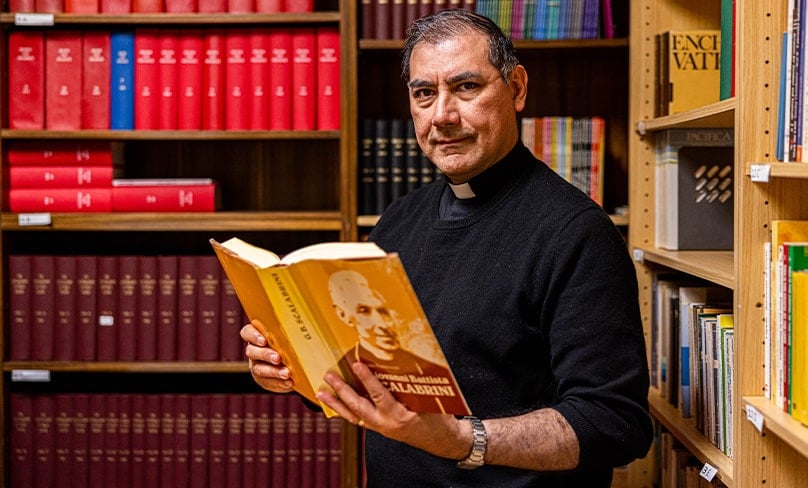Fr Nacho Gutiérrez cs reading about the life of John Scalabrini in his Sydney library. Photo: Alphonsus Fok