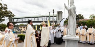 Watched by Fr Greg Skulski SDS and other clergy, Bishop Anthony Randazzo of the Diocese of Broken Bay blesses the new statue of St John Paul II outside St Patrick’s Church in East Gosford last weekend. Photo: Courtesy of the Diocese of Broken Bay