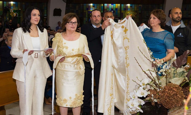 Mrs Josephine Albayeh and Mrs Helen Maroon participate during the vesting of their husbands as priests, above. Photo: Snapix, courtesy Maronite Eparchy