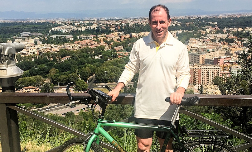 Have bike, will ride: Fr Thomas Casanova with his bicycle on a hill above Rome.