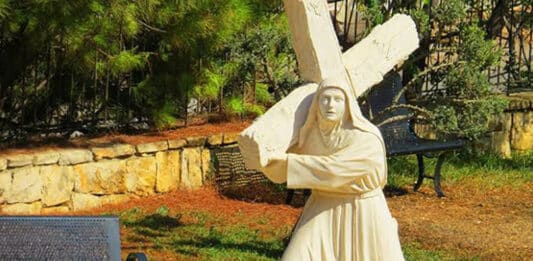 A statue of St Rafqa, known among Maronite Christians as the Lover of the Cross, is depicted carrying the cross of her own sufferings through life. Photo: supplied